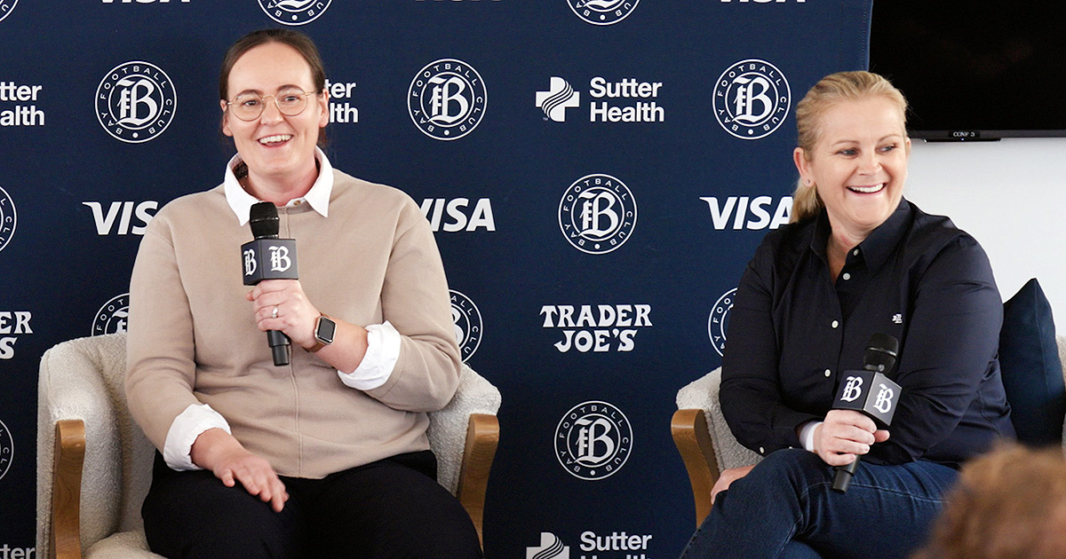 Bay FC Head Coach Emma Coates and CEO of the Bay Collective CEO Kay Cossington share a laugh at Coates' introductory press conference in San Francisco on Dec. 10, 2025.