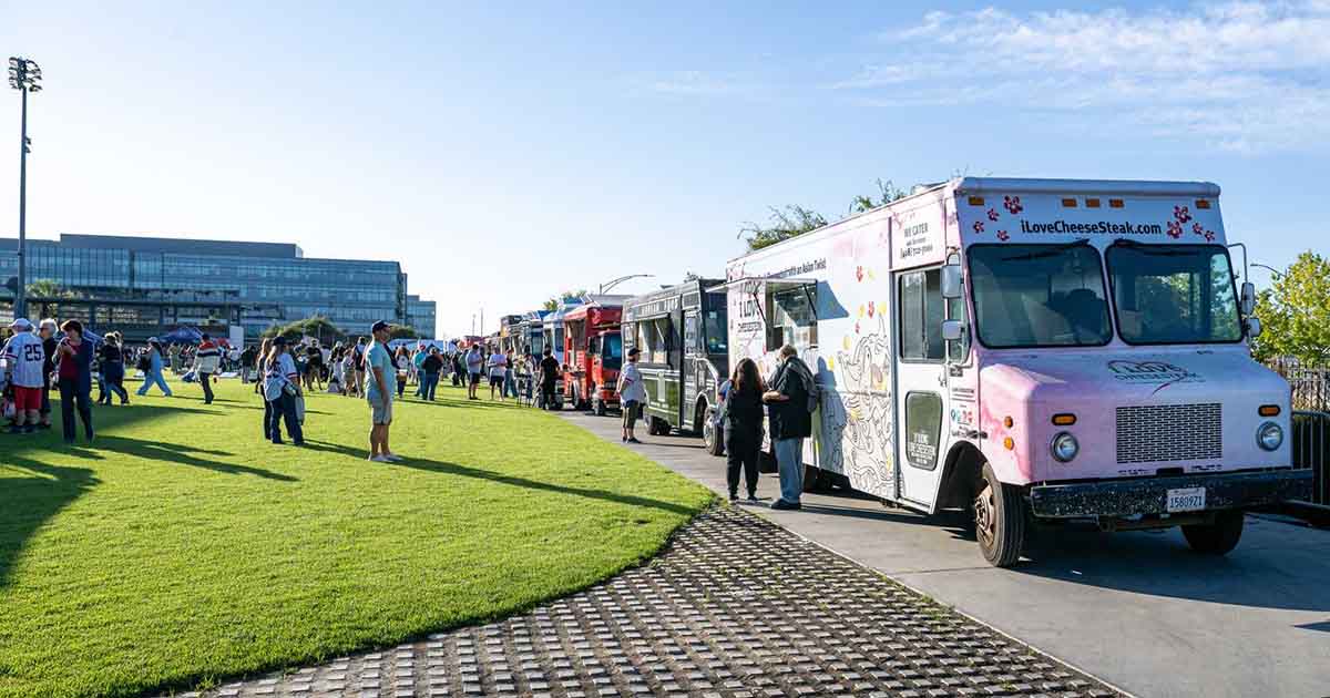 A selection of food trucks parked at PayPal Park for a Bay FC soccer match.